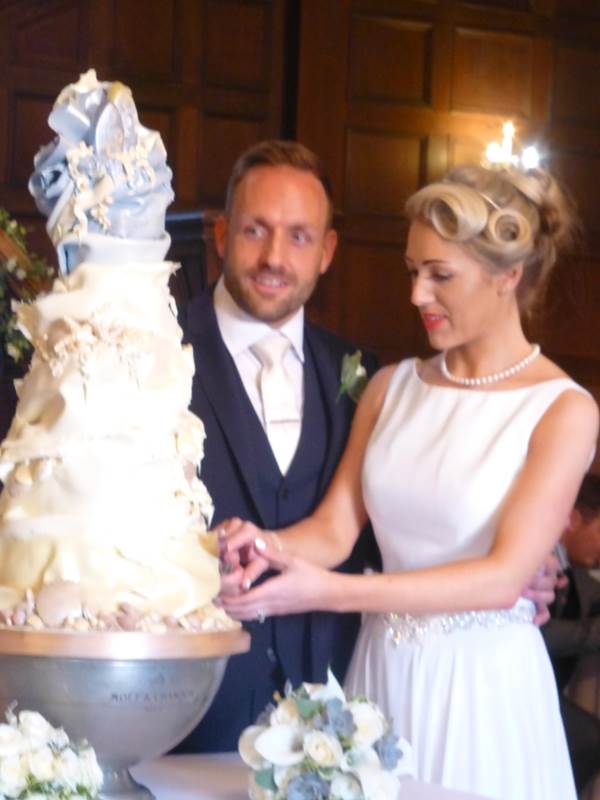 Cutting the fabulous white chocolate wedding cake